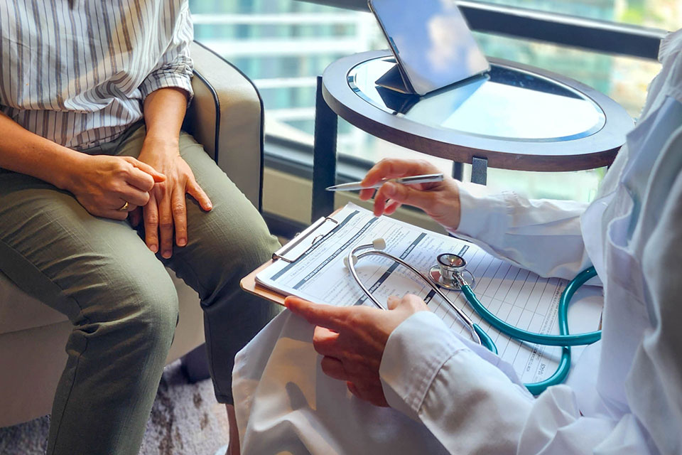 A patient consulting a medical professional in a clinic setting